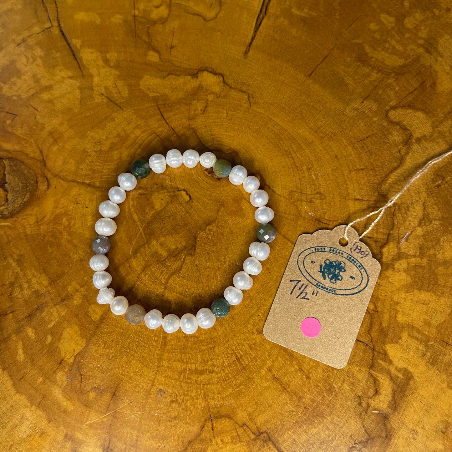 White freshwater Pearls with faceted Jasper on elastic, 7 1/2" on a wooden surface with tag