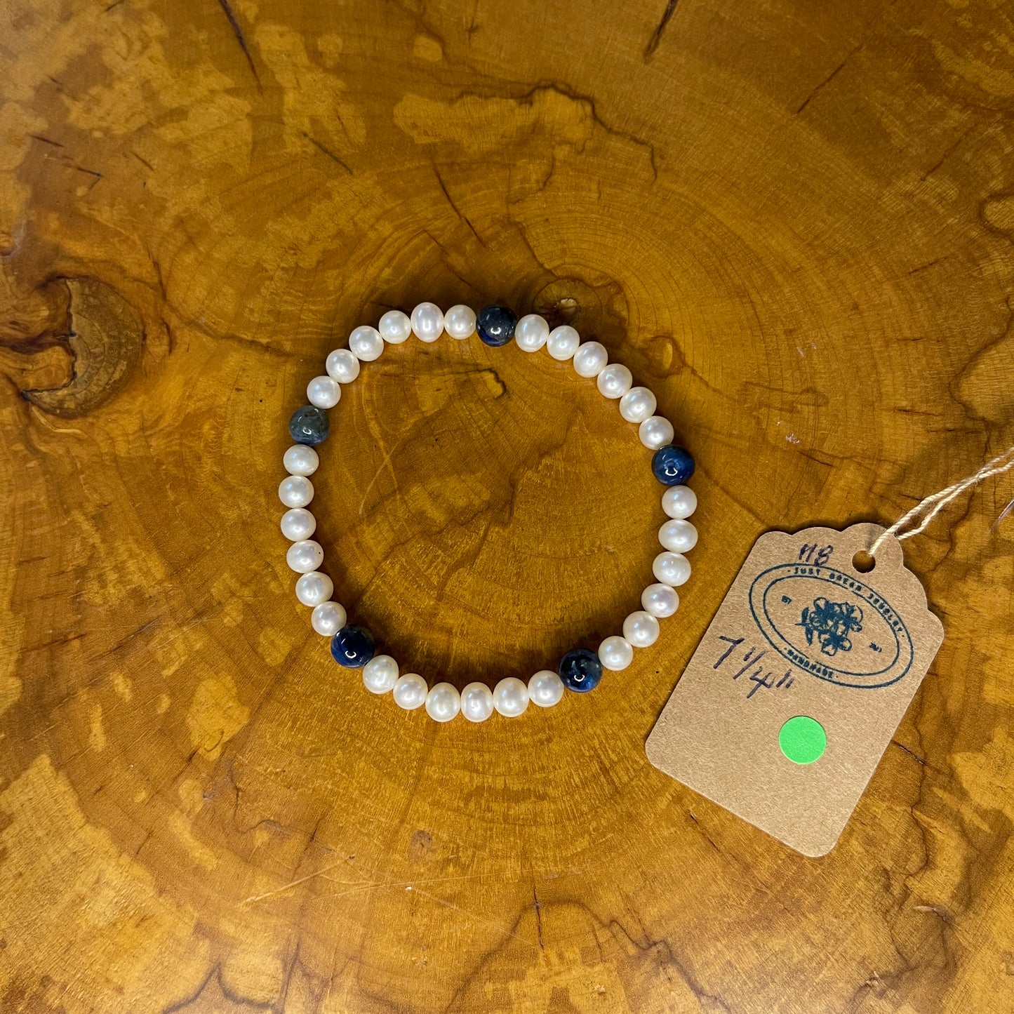 Freshwater Pearls with Kyanite on elastic, 7 1/4" on wooden surface with tag