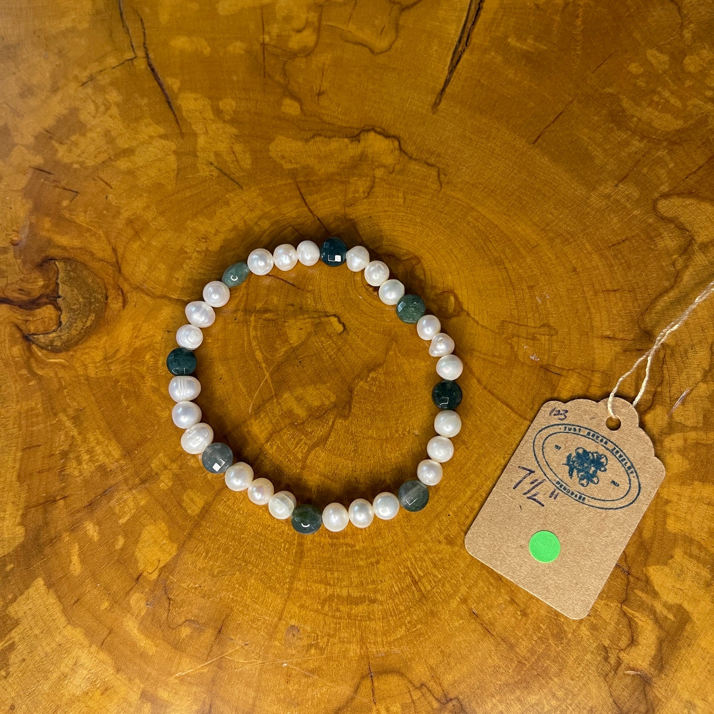 White freshwater Pearls with Green faceted Jasper rondelle on elastic, 7 1/2"on wood