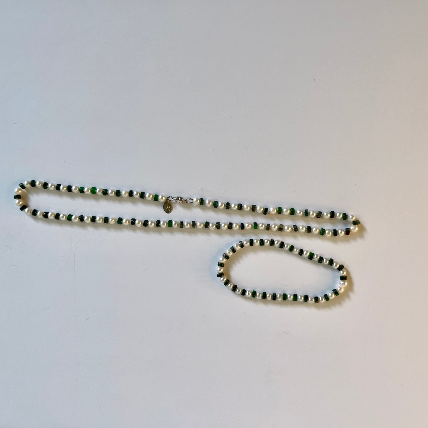 White Pearl and green jasper necklace and bracelet set on white background