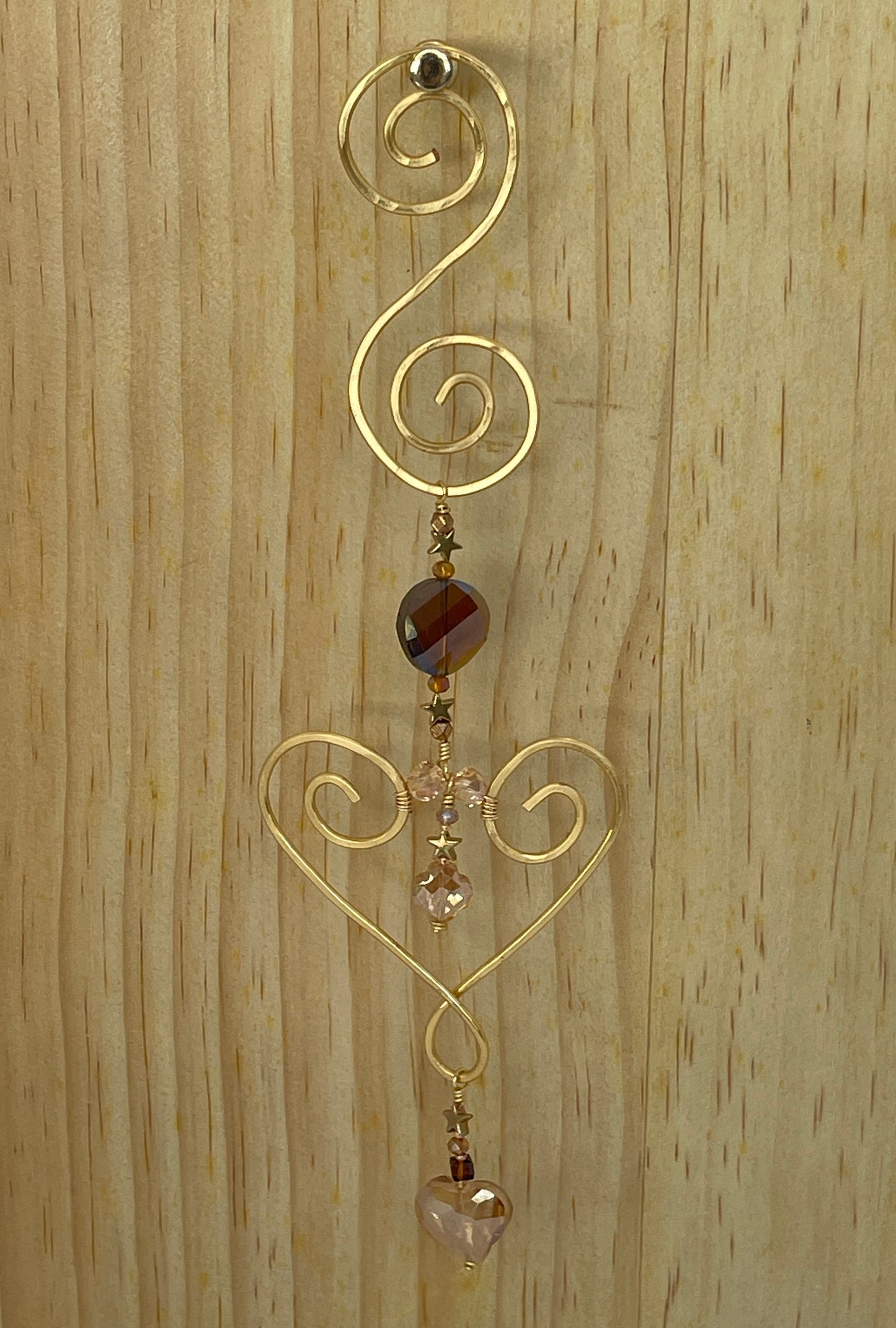 Heart shaped Decorative gold tone hammered metal wall/window Suncatcher with round red brown crystal ending with a Taupe heart shaped crystal drop, 10"