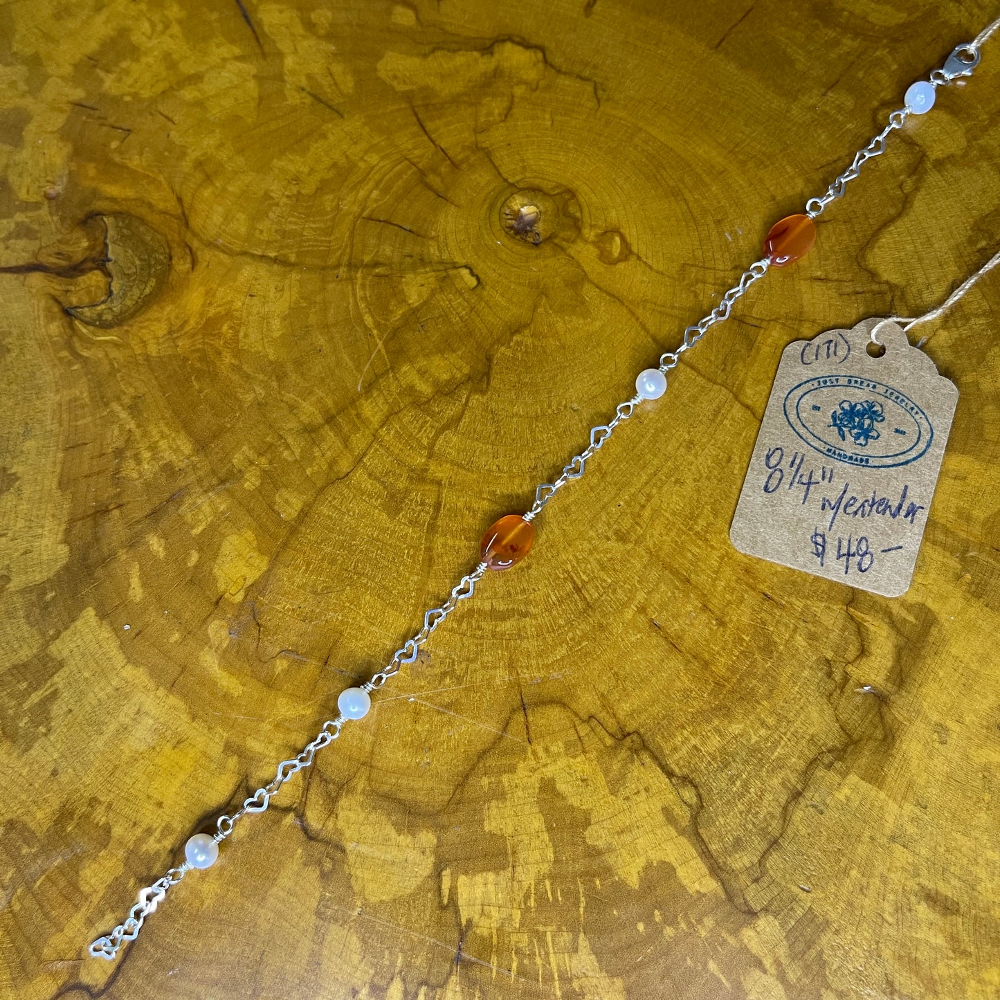 Oval carnelian with Freshwater pearl on Sterling Silver Heart chain, 8 inches with 1/2 inch extender on wooden surface with tag