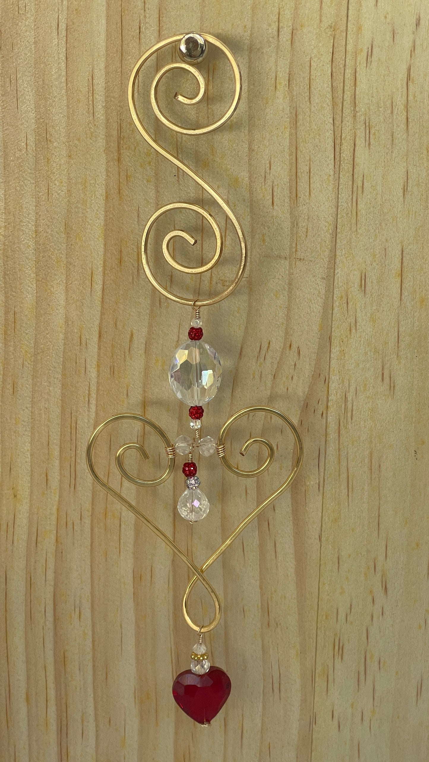 Heart shaped Decorative gold tone hammered metal wall/window Suncatcher with oblong clear crystal to clear crystal teardrop with red crystal accents ,ending with a Red Heart shaped crystal drop, 10"