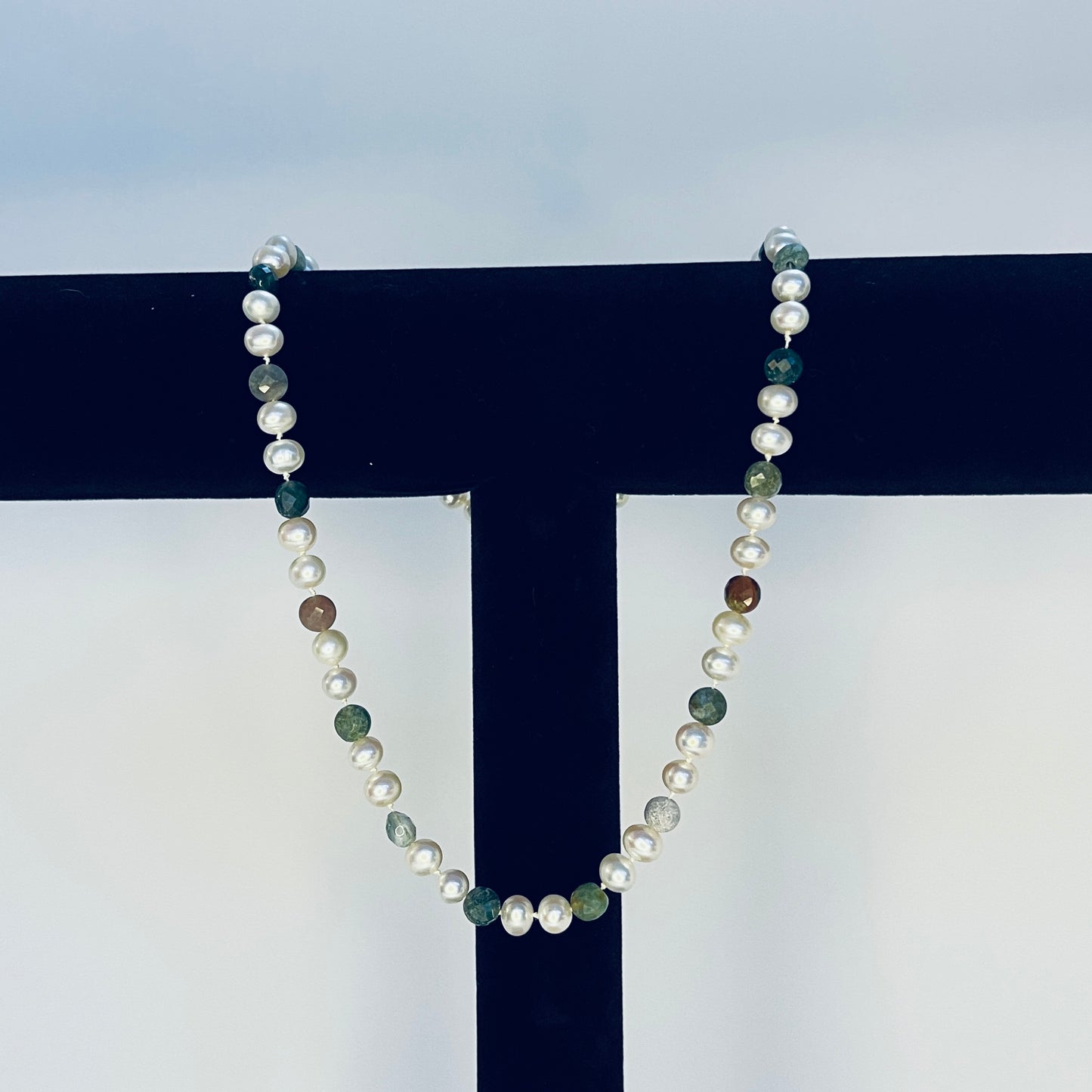 Pearl Necklace with multicolored Jasper beads on a black and white background