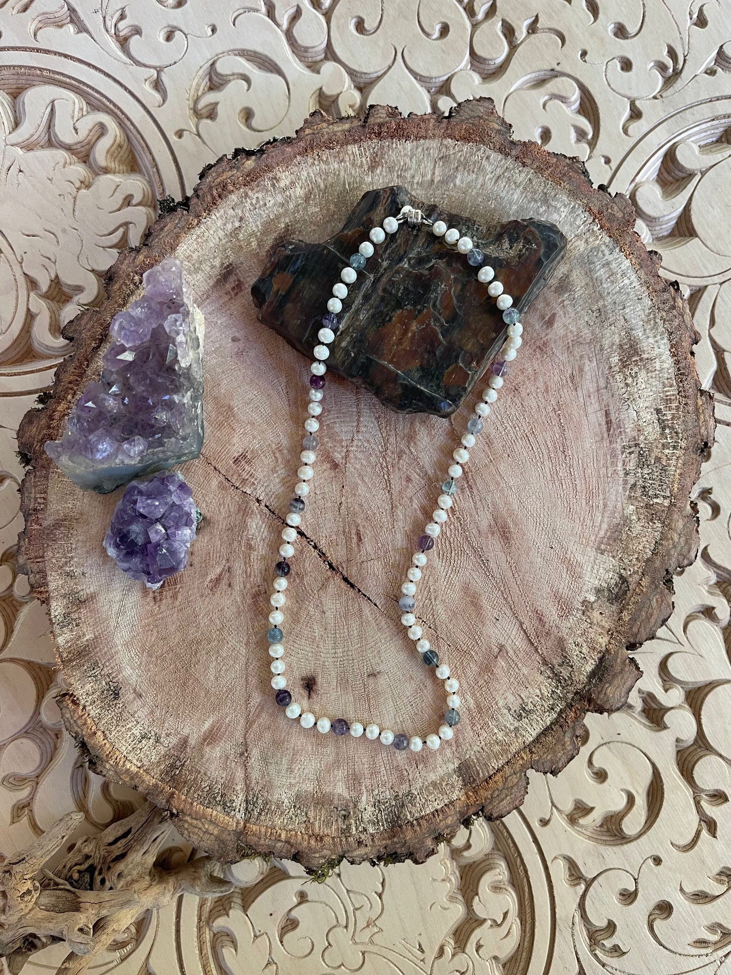 White Pearl and Fluorite beaded necklace on a wooden surface