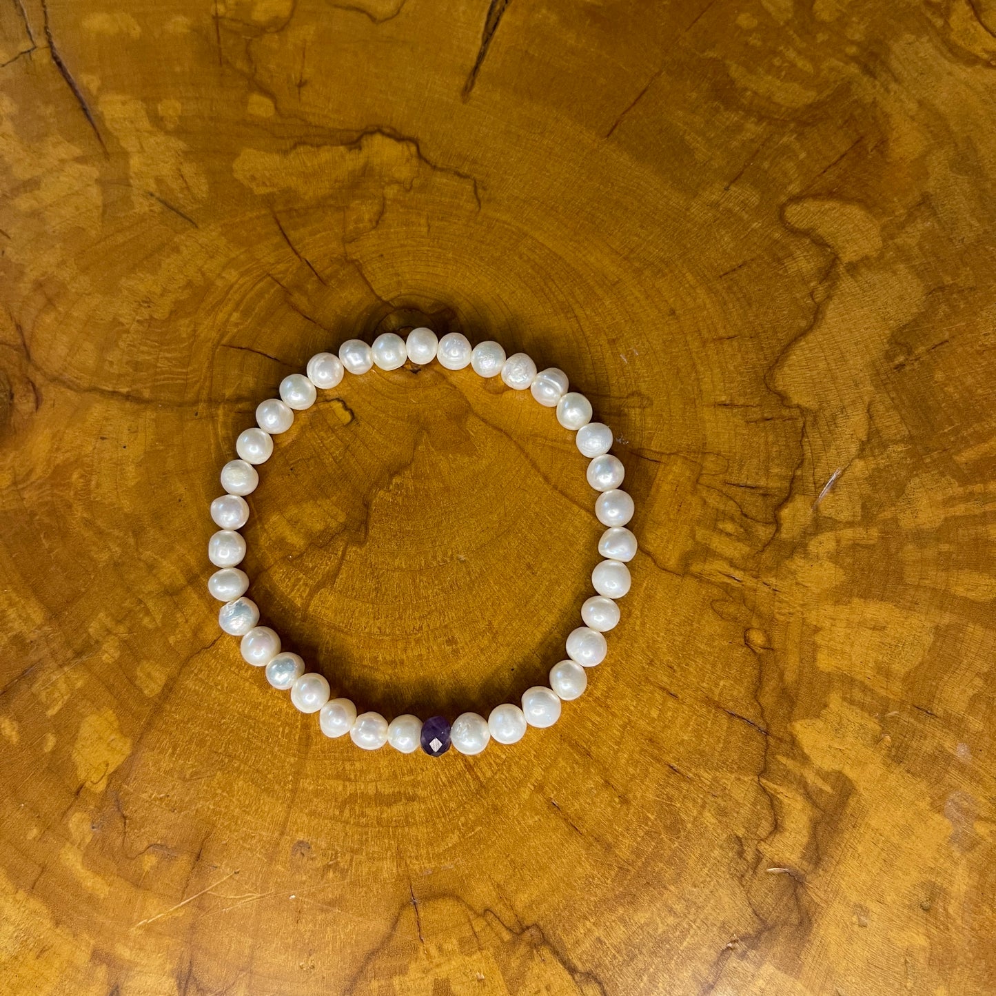 White freshwater Pearls with red faceted Jasper rondelle on elastic, 7 1/2"on wood