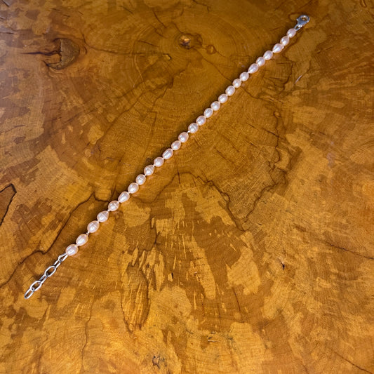 Mauve Freshwater Rice Pearls on Silk,7 3/4" with 1" Sterling Silver extender chain, Sterling Silver Lobster clasp on wood