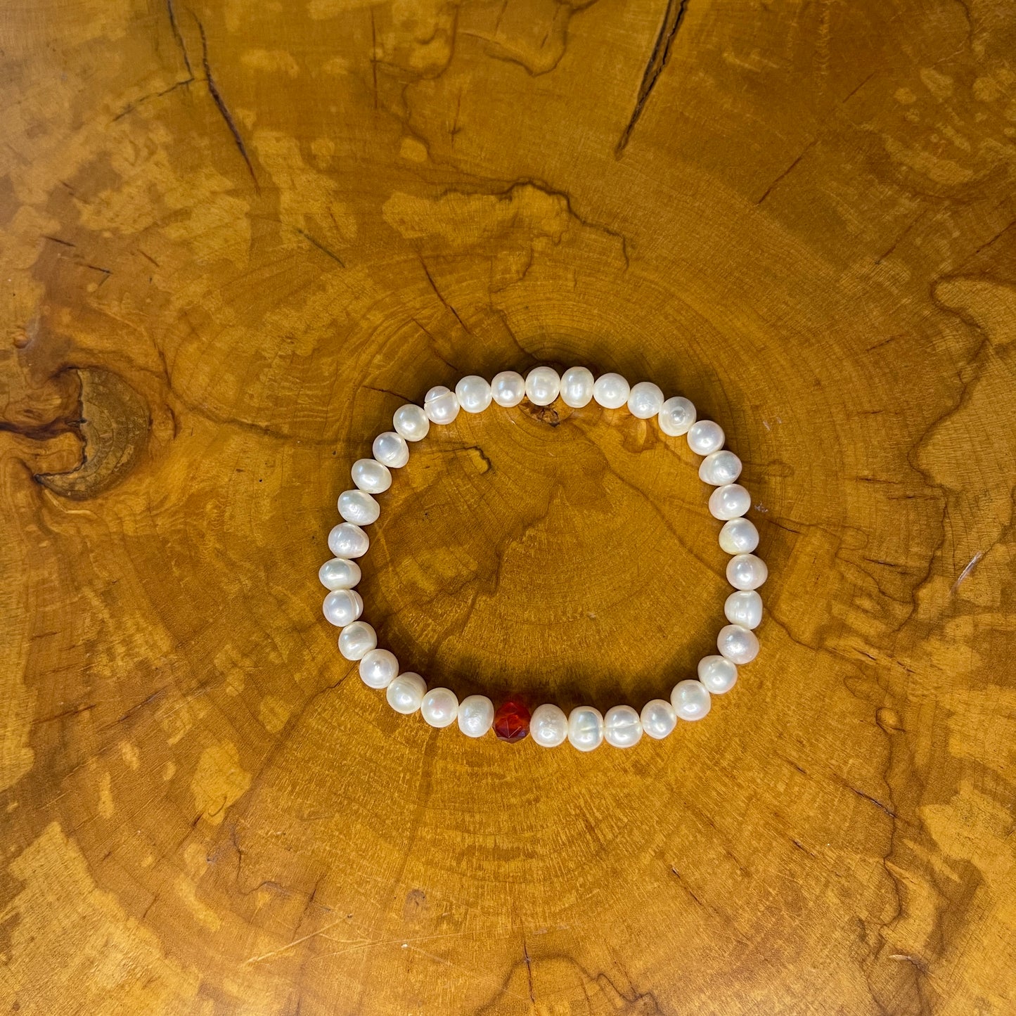 White Freshwater Pearls with faceted Carnelian on elastic, 7 1/2" on wood