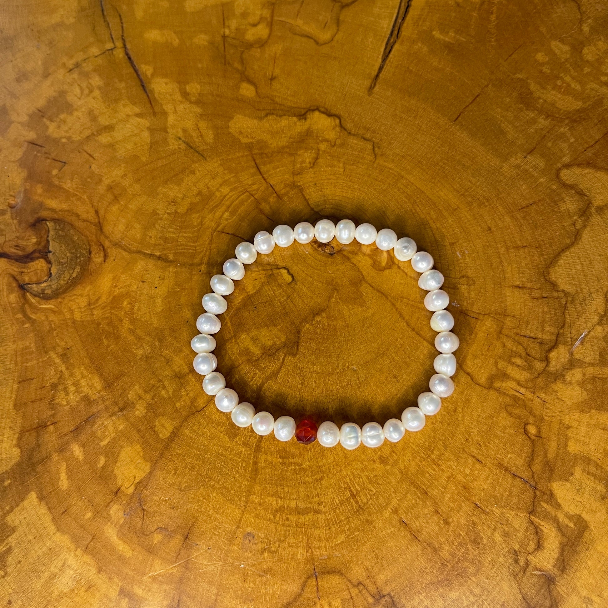 White Freshwater Pearls with faceted Carnelian on elastic, 7 1/2" on wood