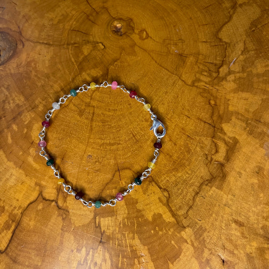 Multi Colored Jade on Sterling Silver wire with Sterling Silver Lobster clasp, 8" on wood