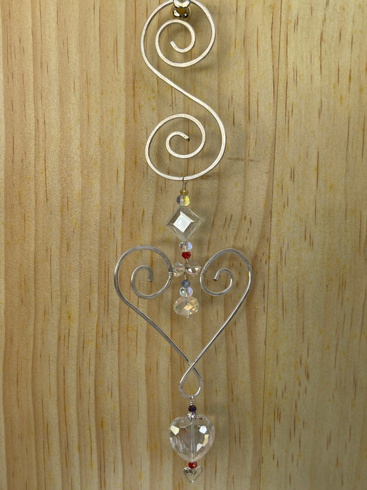 Decorative wall/window Suncatcher with Heart shaped crystal accents on a wooden surface, 10"