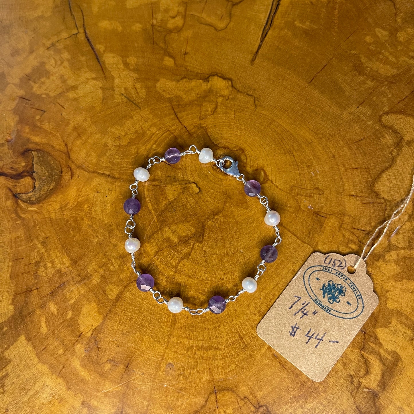 Faceted Amethyst and freshwater White pearls on Sterling Silver wire, 7 1/4" Sterling Silver Lobster Clasp on wood