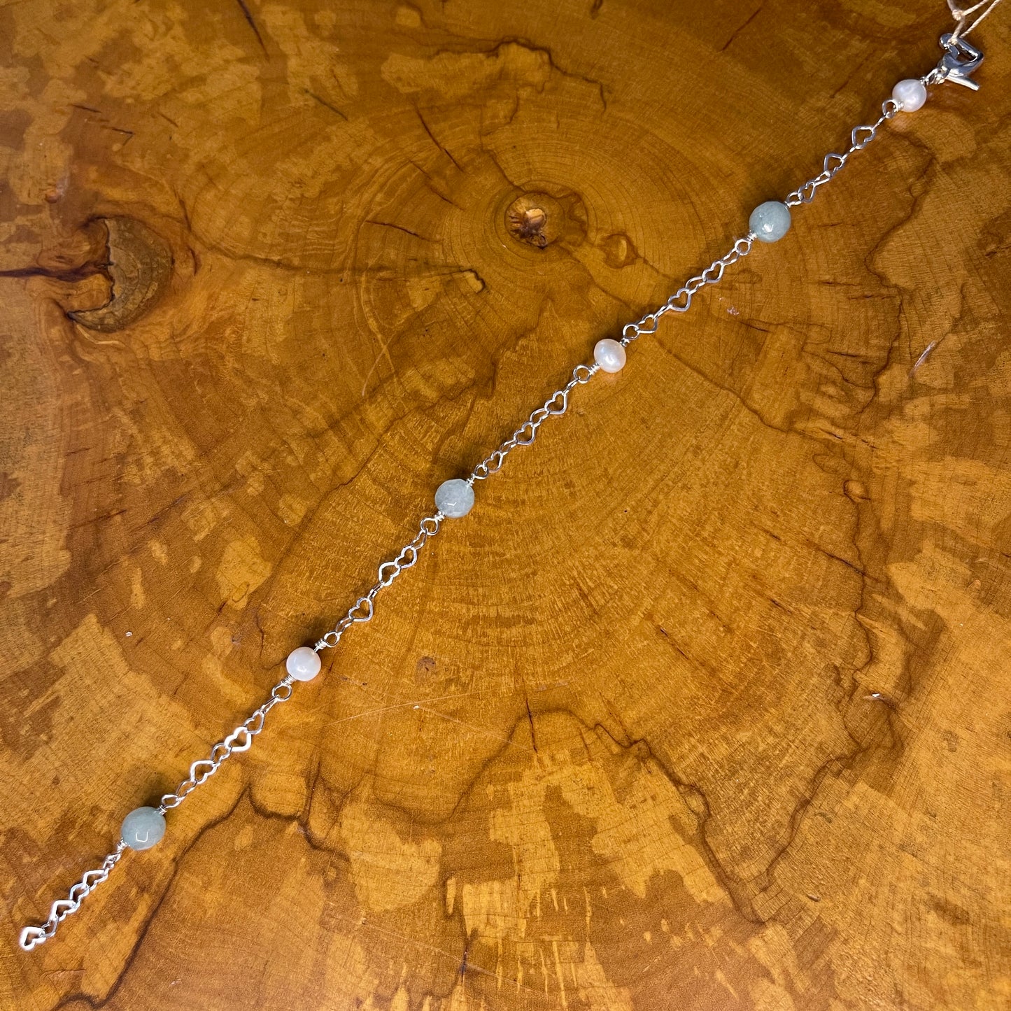Sterling Silver heart Chain with White Freshwater pearls and Amazonite, 8 1/2" with Sterling Heart extender, Sterling Silver Heart Lobster Clasp o a wooden slab