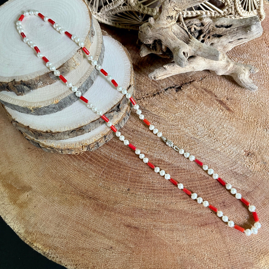 Coral and Pearl necklace on wood with driftwood