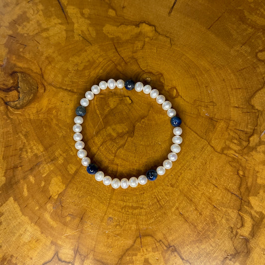 Freshwater Pearls with Kyanite on elastic, 7 1/4" on wooden surface