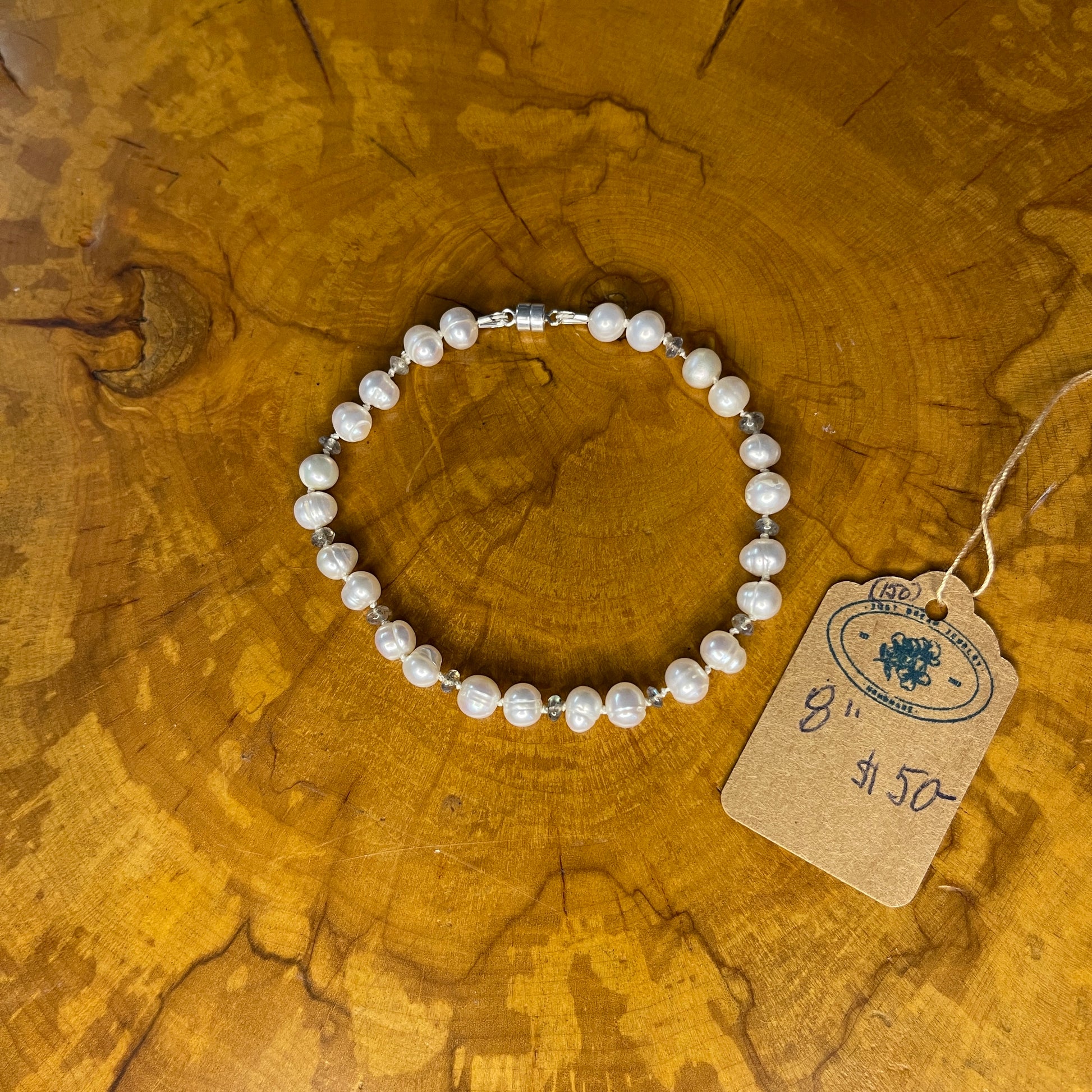 Freshwater White Pearls with Black Opal seed beads on Silk with sterling Silver magnetic clasp, 8" on wood