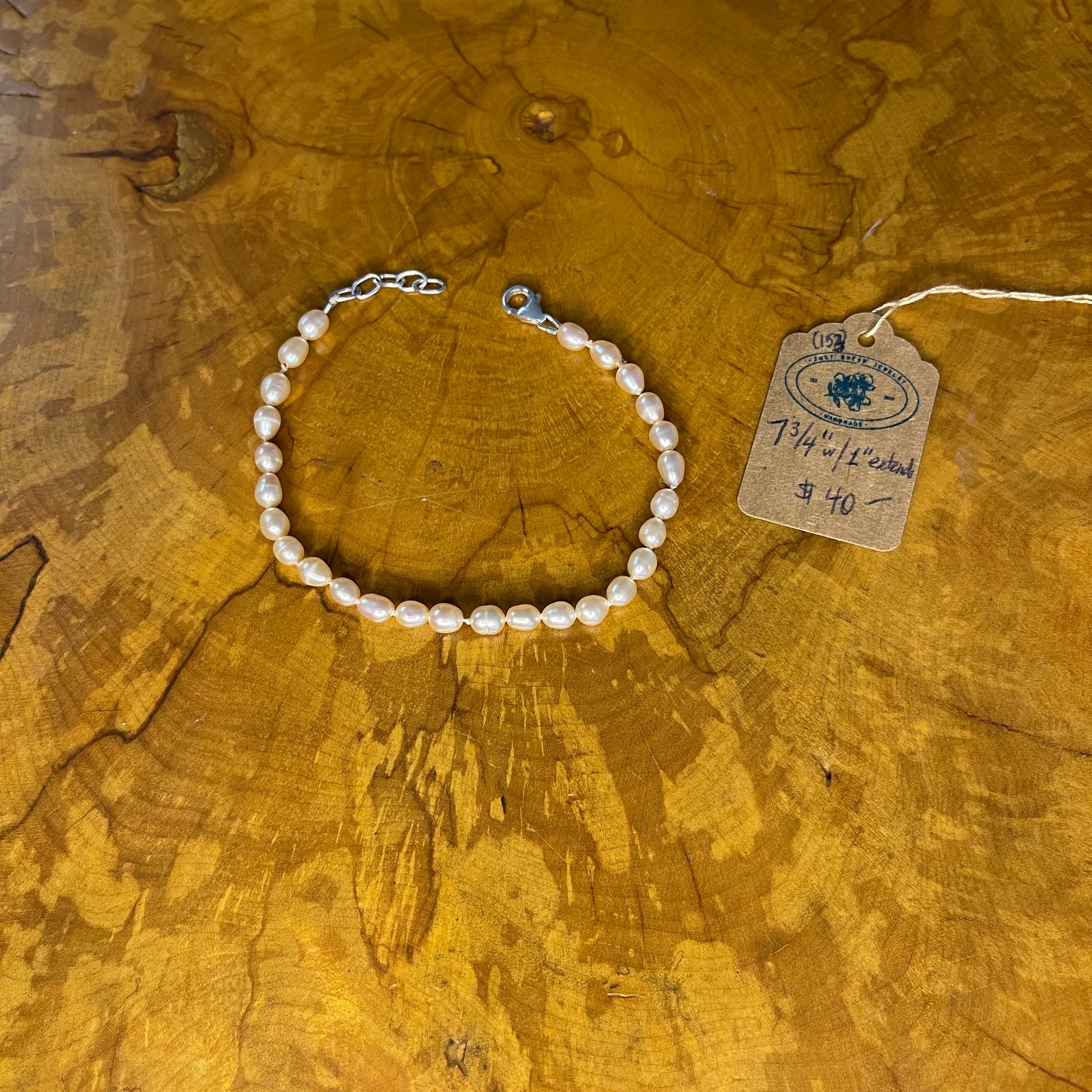 Mauve Freshwater Rice Pearls on Silk,7 3/4" with 1" Sterling Silver extender chain, Sterling Silver Lobster clasp on wood