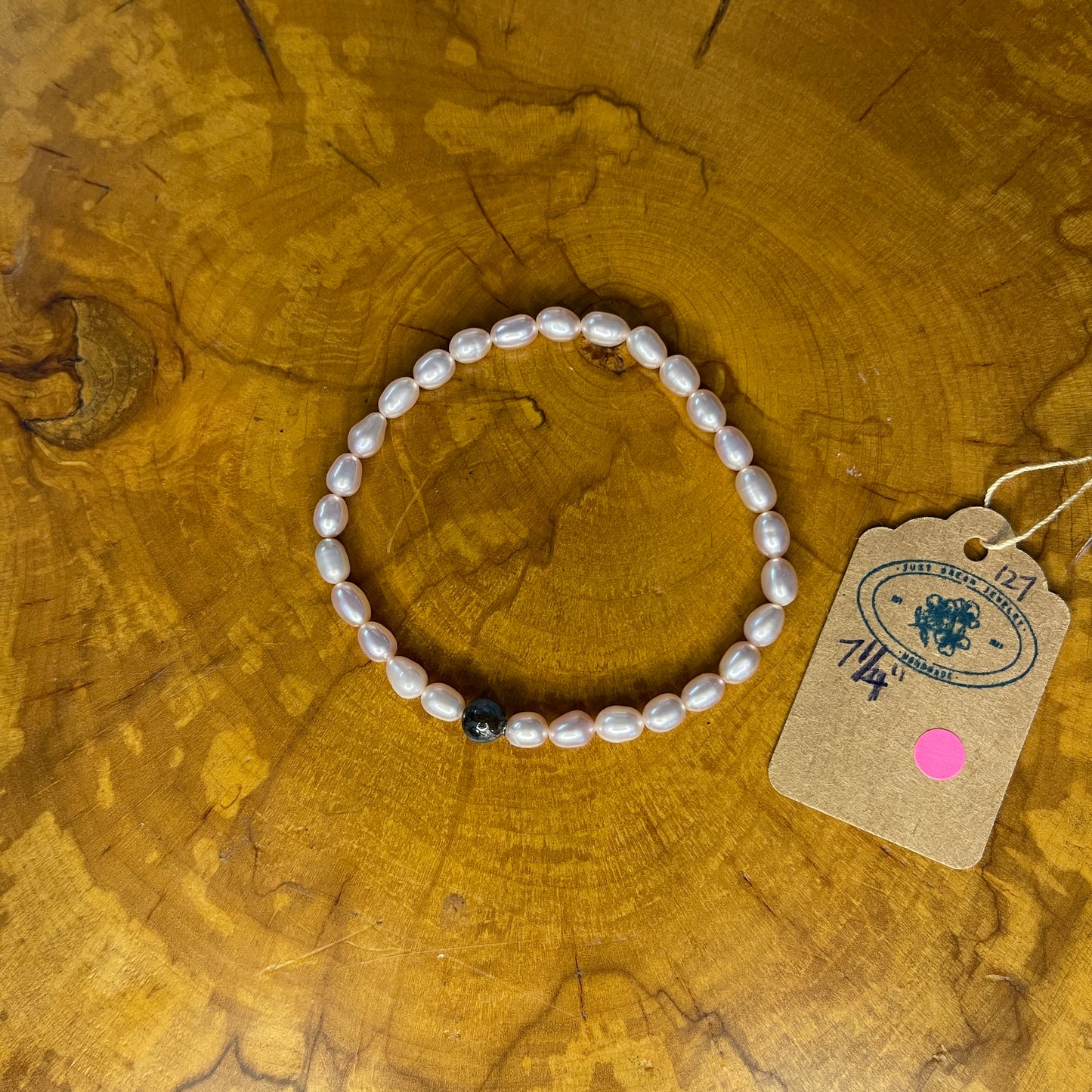 Mauve Freshwater Pearls with Blue Kyanite Bracelet on elastic, 7 1/4" on wooden surface