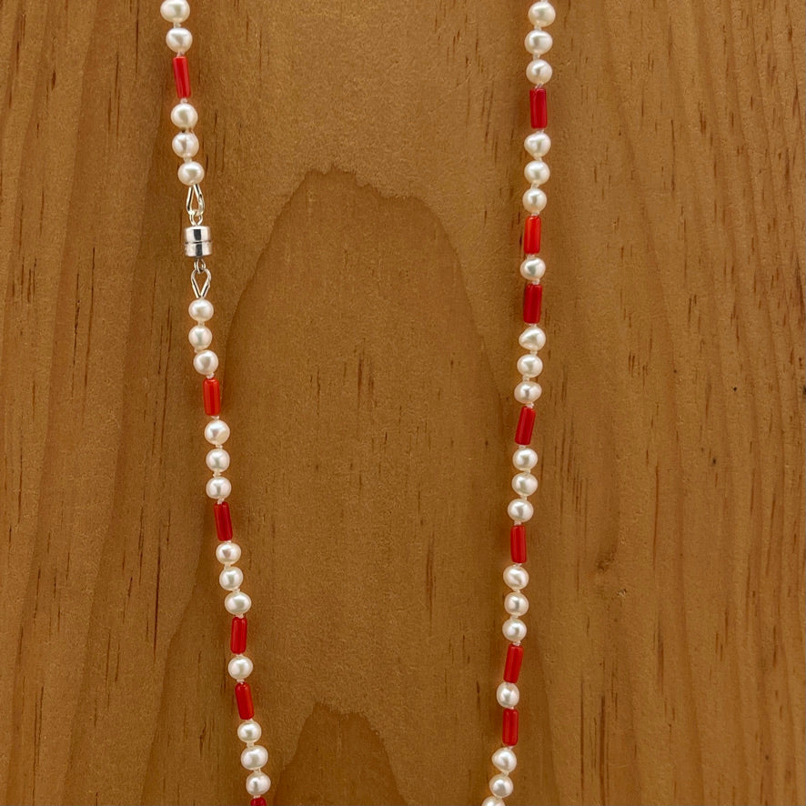 Coral and Pearl necklace on wood 