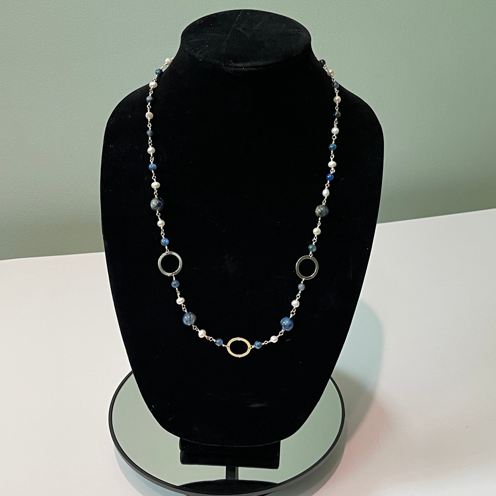 Pearls and Kyanite blue beads hand tooled on Sterling Silver wire on black mannequin bust