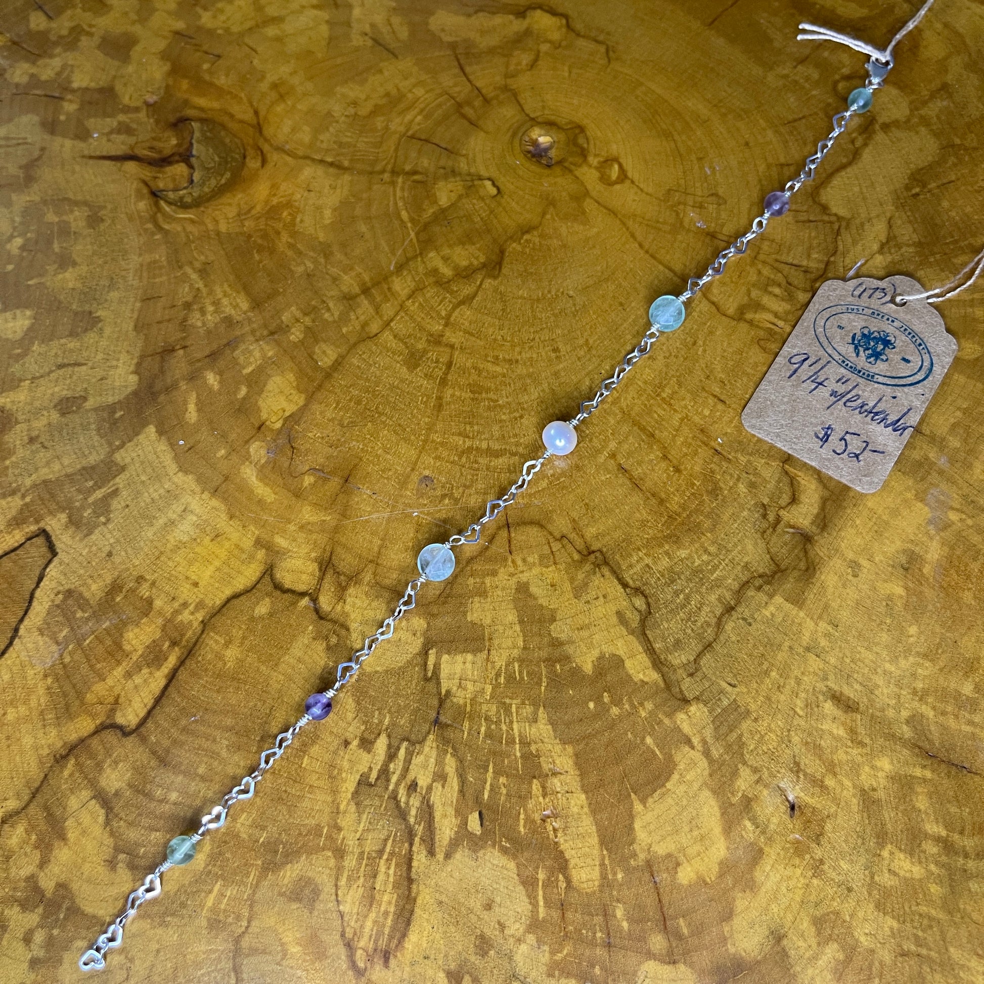 Fluorite and Freshwater Pearl on Sterling Silver Heart chain, 9 inch with 1/2 inch extender and Sterling Silver Lobster clasp on wooden surface with tag