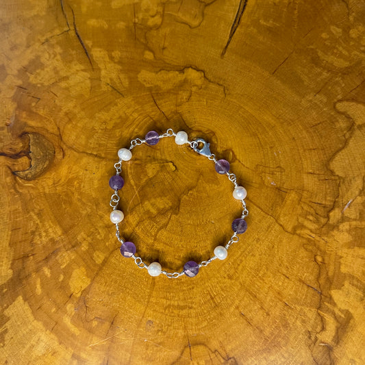 Faceted Amethyst and freshwater White pearls on Sterling Silver wire, 7 1/4" Sterling Silver Lobster Clasp on wood