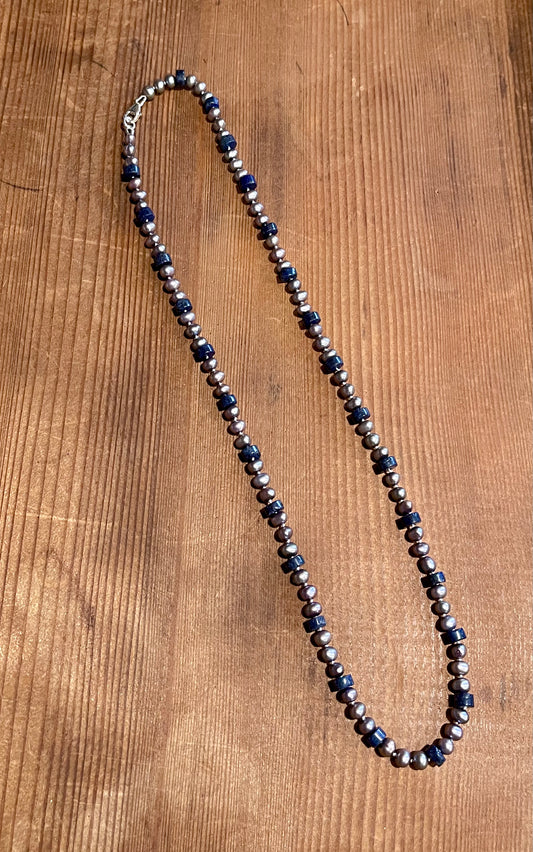 6mm silver freshwater pearls dance alongside rich lapis lazuli heishi discs necklace on wood