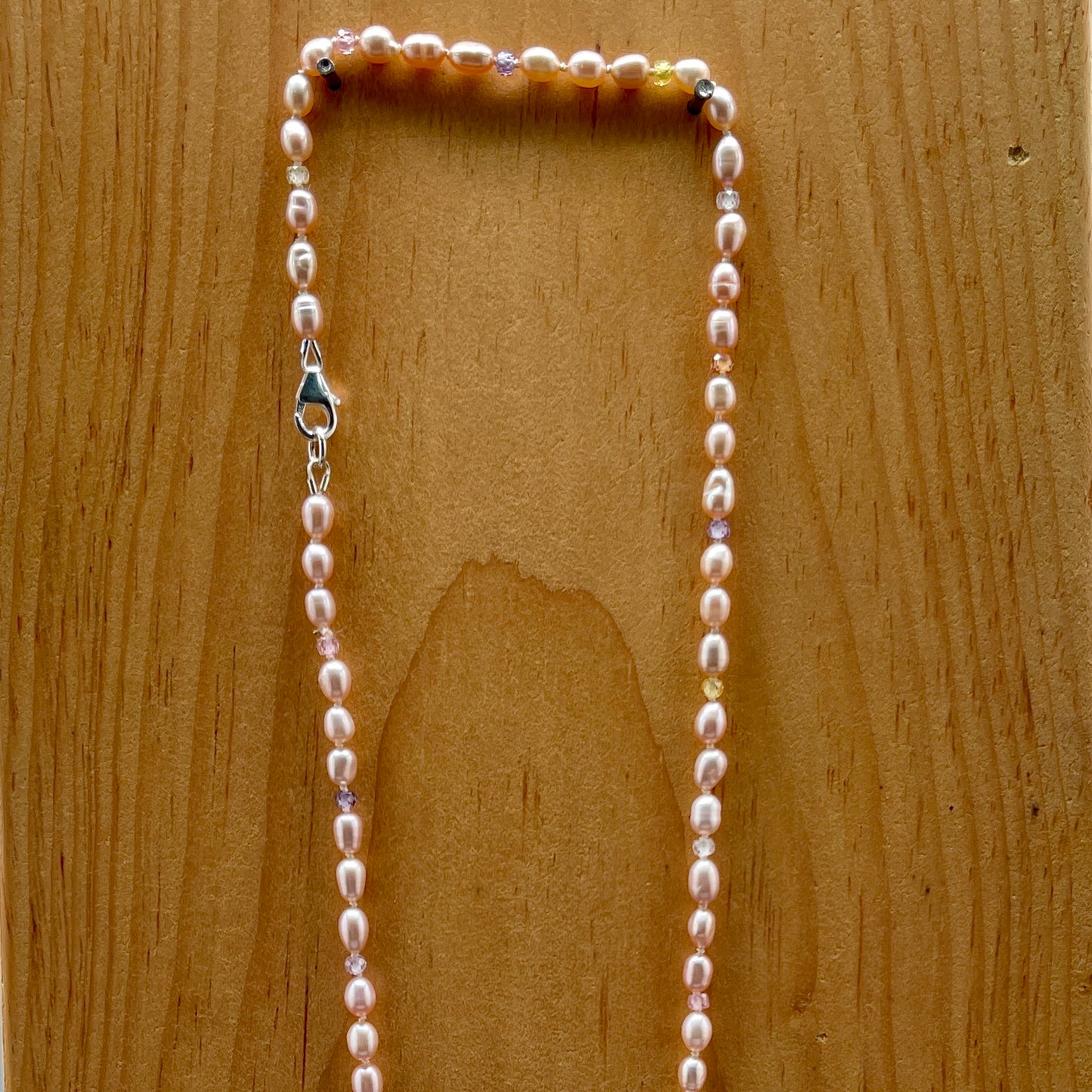 Pearl necklace on a wooden surface