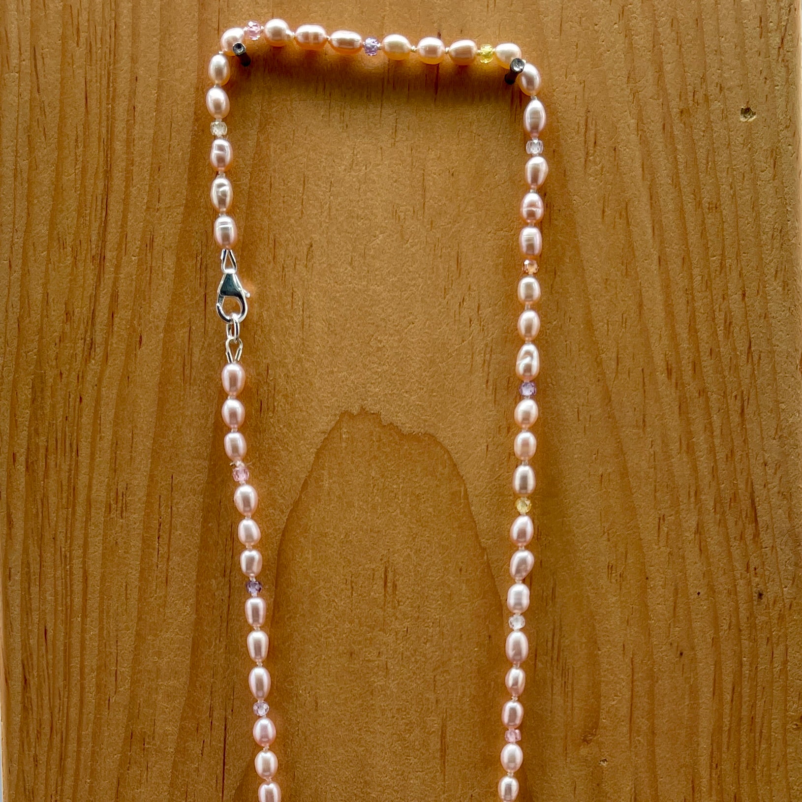Pearl necklace on a wooden surface
