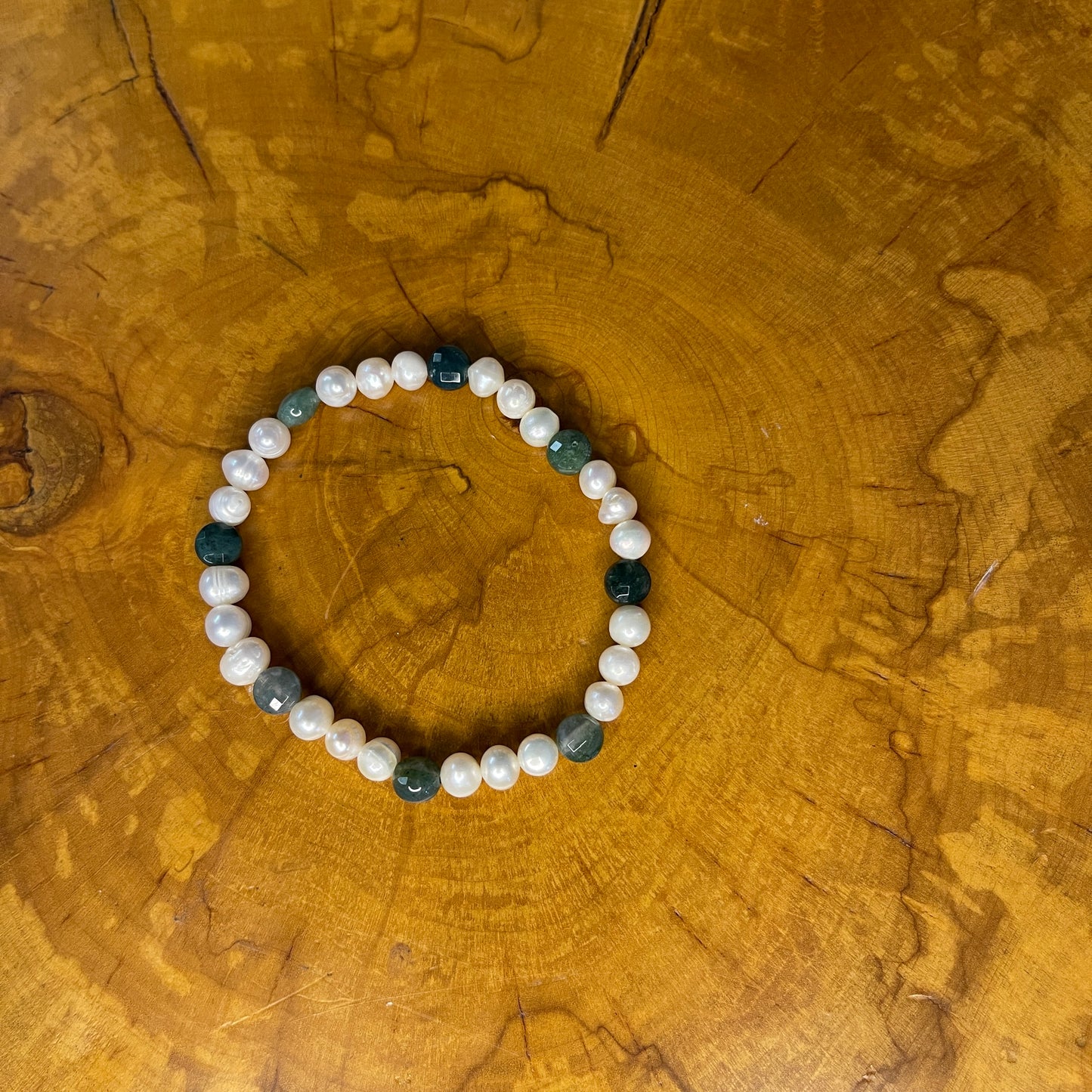 White freshwater Pearls with Green faceted Jasper rondelle on elastic, 7 1/2" on wood