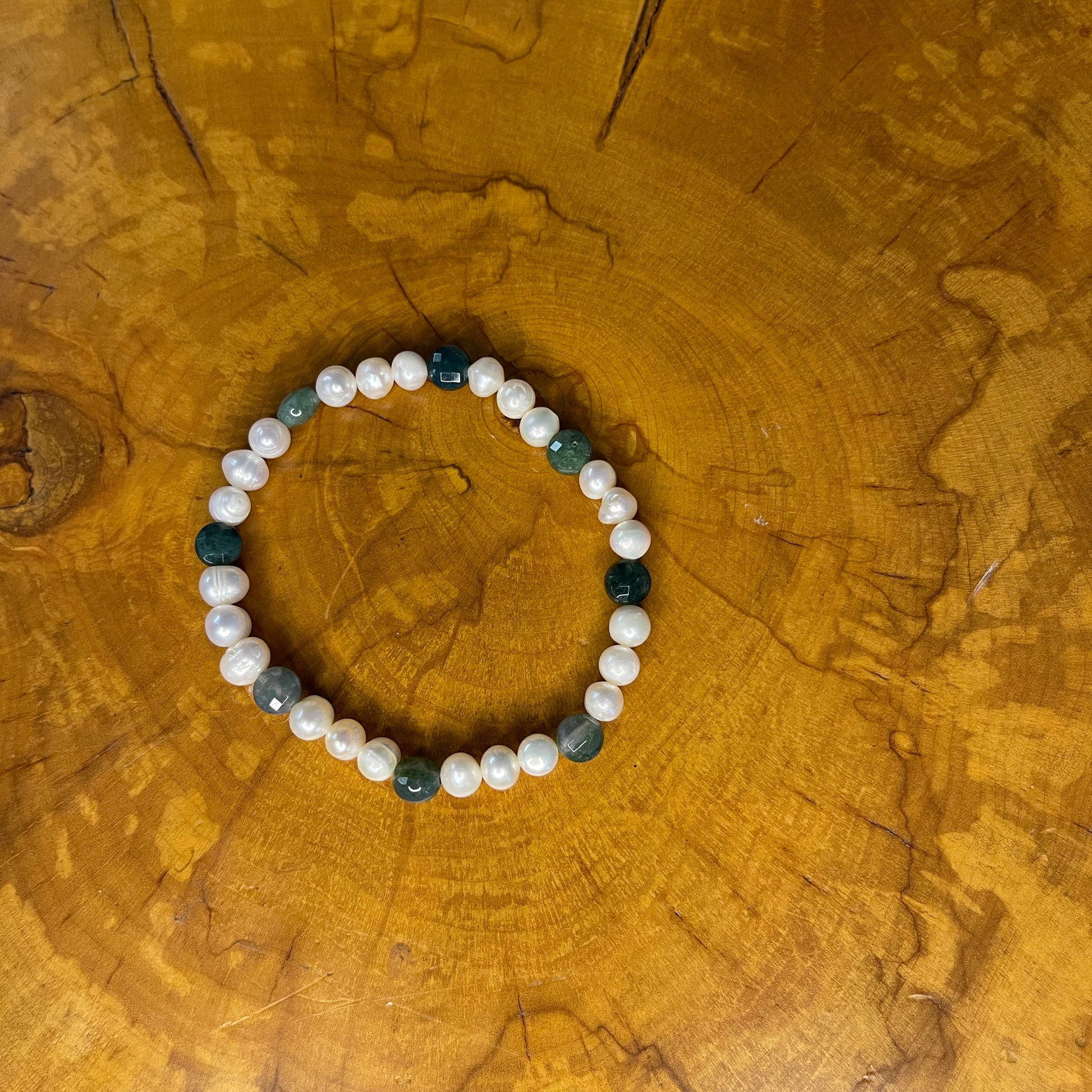 White freshwater Pearls with Green faceted Jasper rondelle on elastic, 7 1/2" on wood