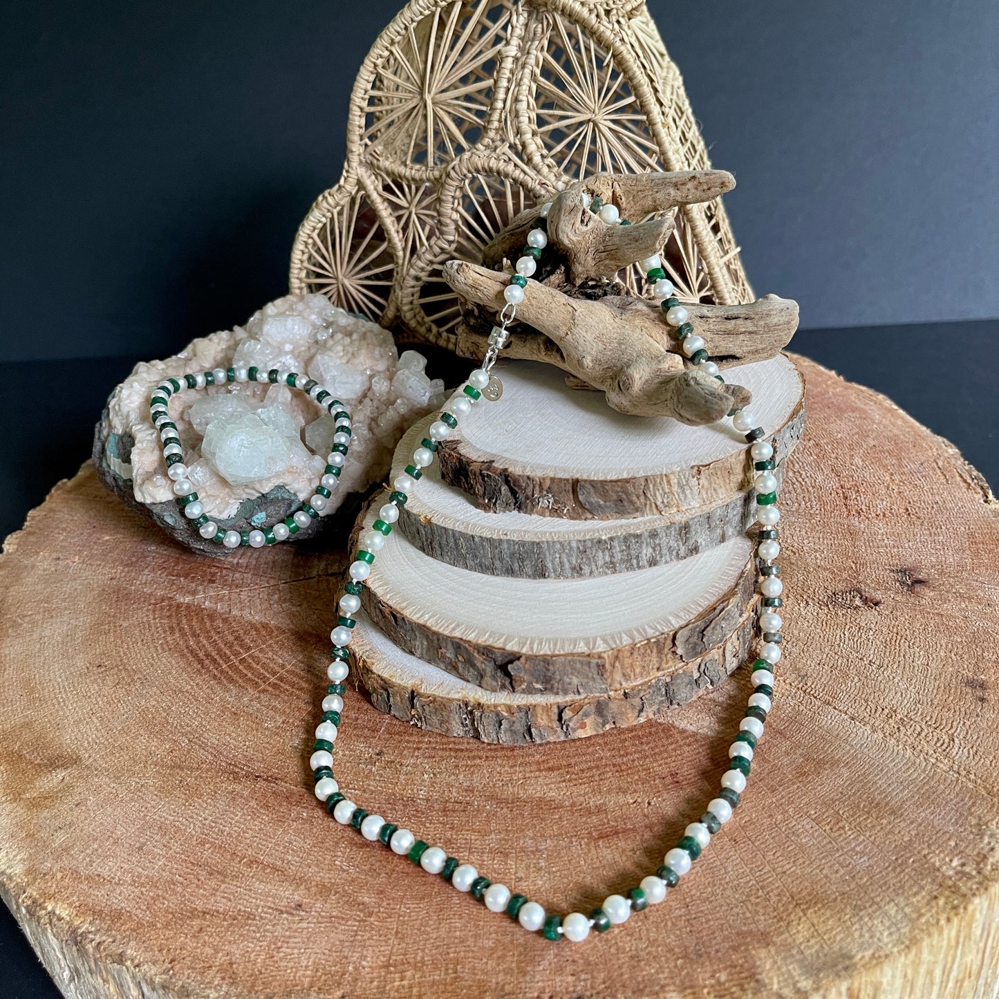 White Pearl and green jasper necklace and bracelet set on wooden slab with decorative elements