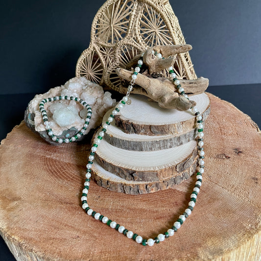 White Pearl and green jasper necklace and bracelet set on wooden slab with decorative elements