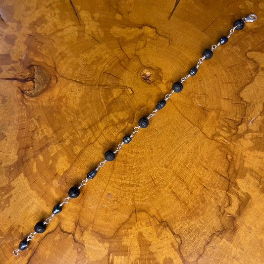 Dark Peacock Freshwater Pearls and Lava beads on Sterling Silver wire with Sterling Silver Lobster clasp, 8" on wood