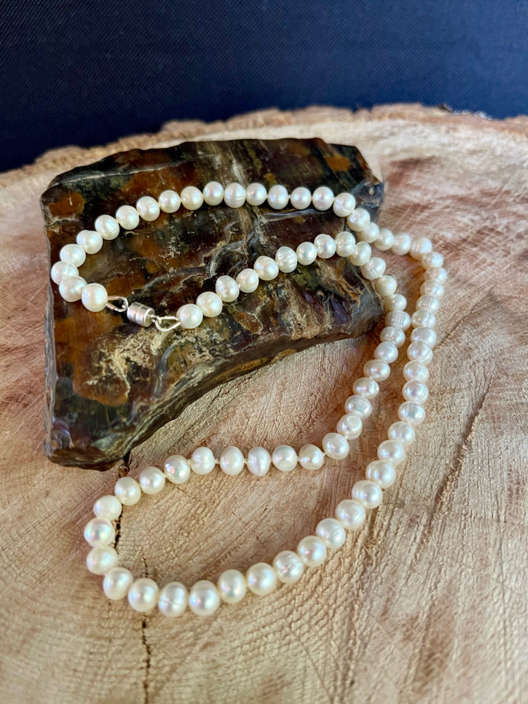 Pearl necklace on a wooden surface with a dark background