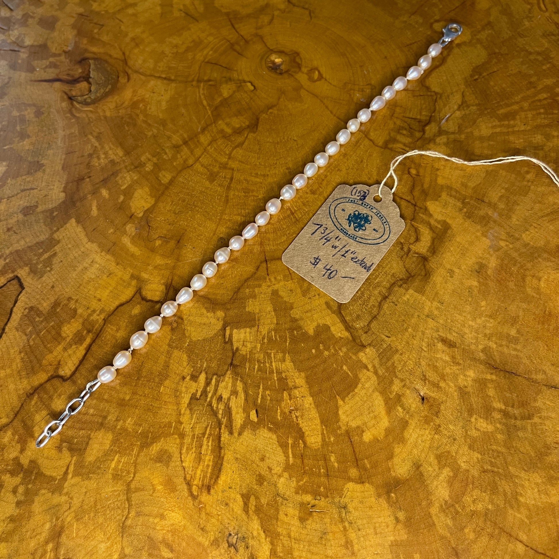 Mauve Freshwater Rice Pearls on Silk,7 3/4" with 1" Sterling Silver extender chain, Sterling Silver Lobster clasp on wood