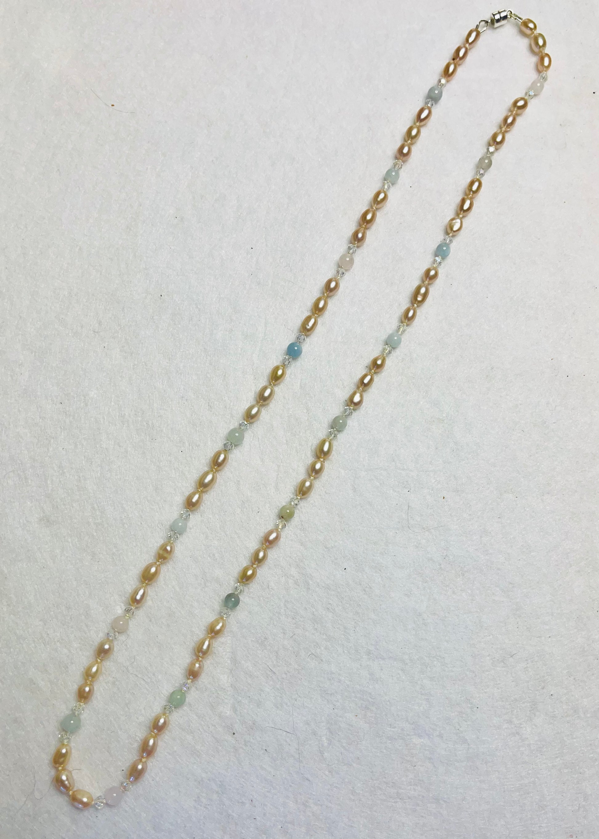 necklace with Pearls, Morganite and crystal necklace on a light background