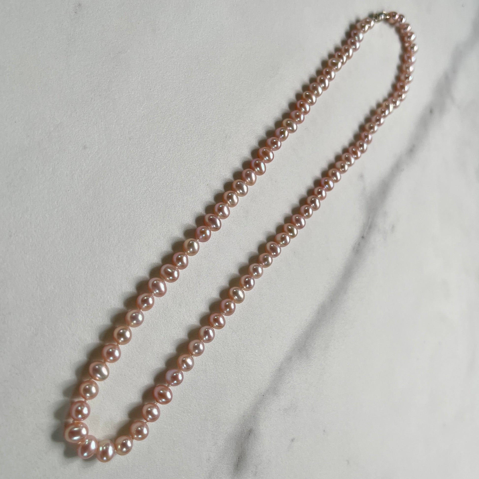 Pink Pearl necklace on marble