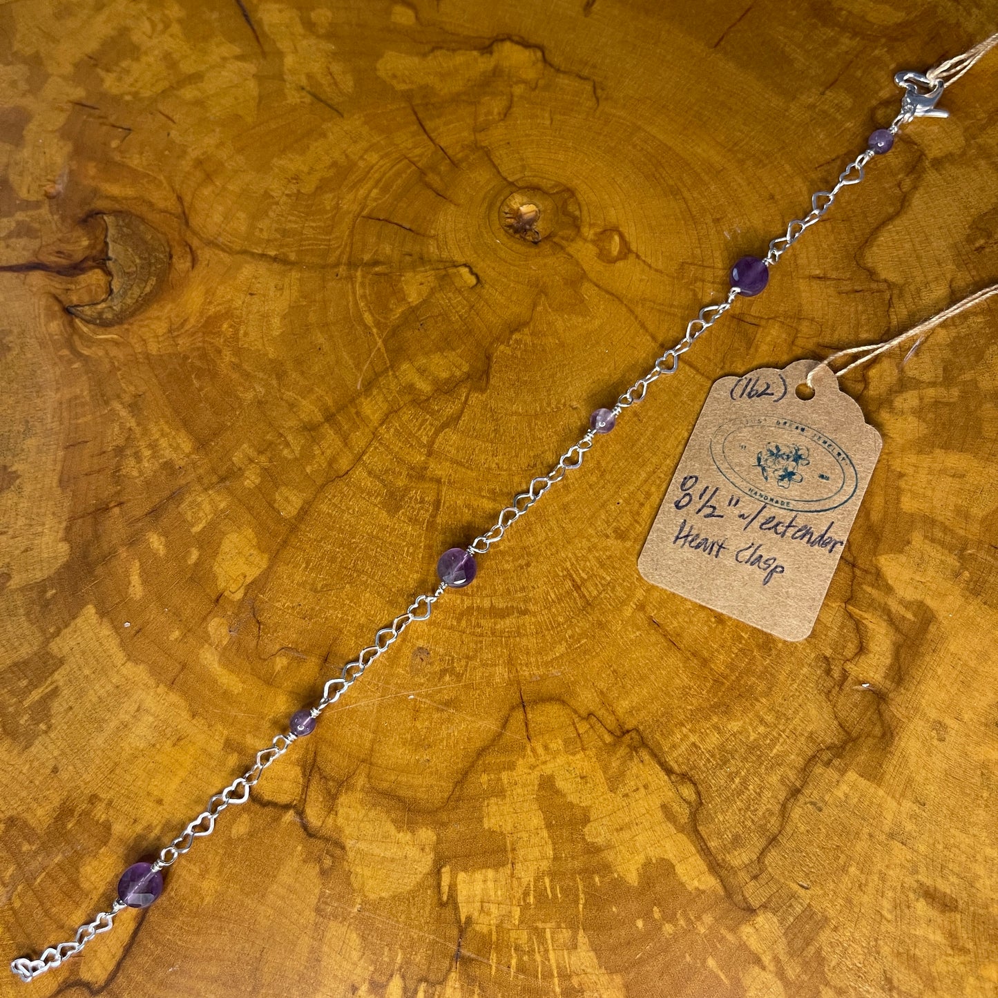 Sterling Silver heart Chain with faceted Amethyst, 8 1/2" with Sterling Heart extender, Sterling Silver Heart Lobster Clasp on wooden slab