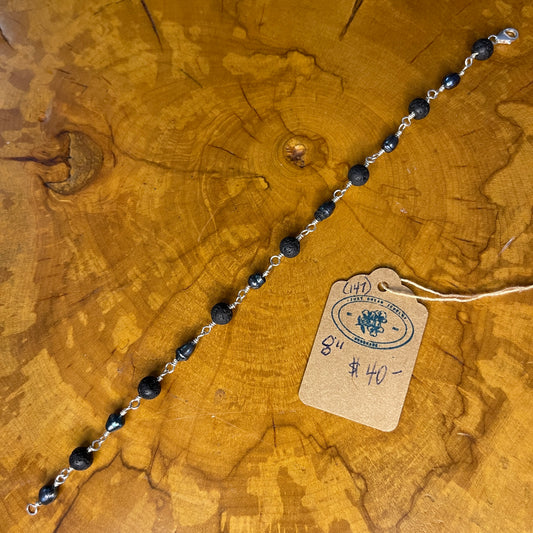 Peacock Freshwater Pearls with Lava beads on Sterling Silver wire, 8" SS Lobster clasp on wooden surface with tag