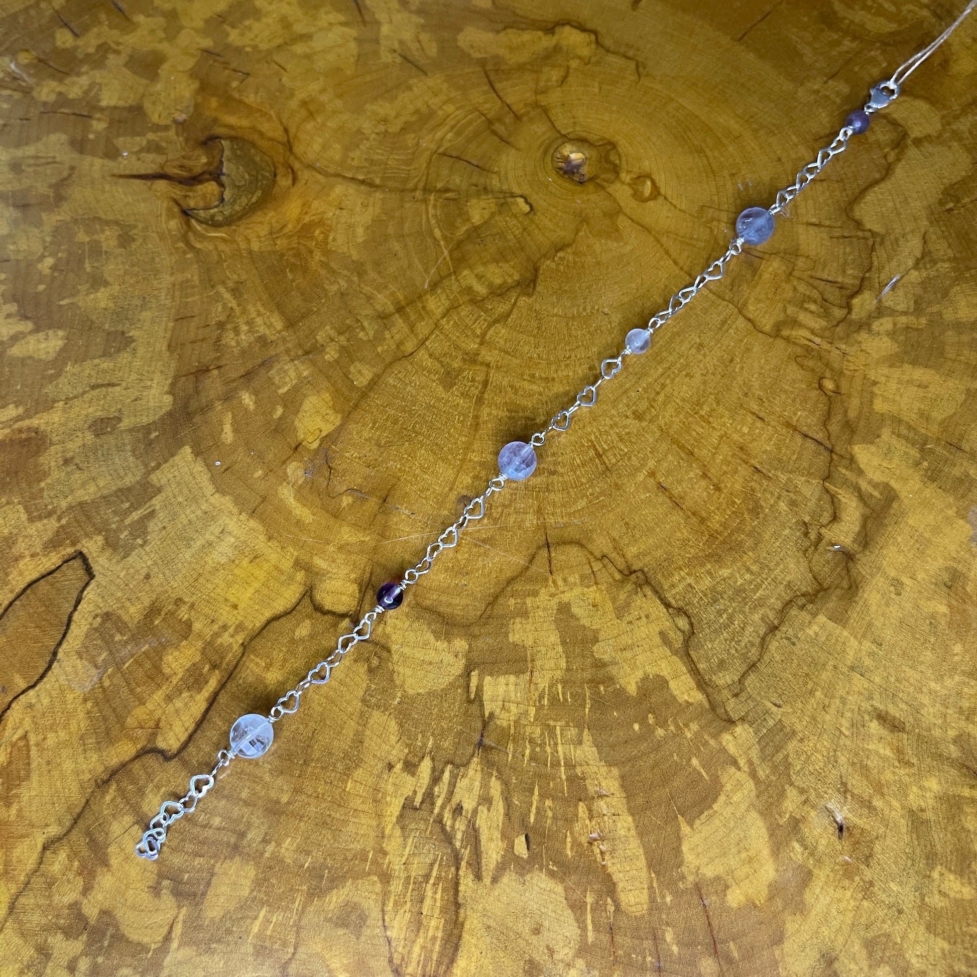 Sterling silver Heart chain bracelet with Fluorite beads on a wooden surface, 8 1/2"