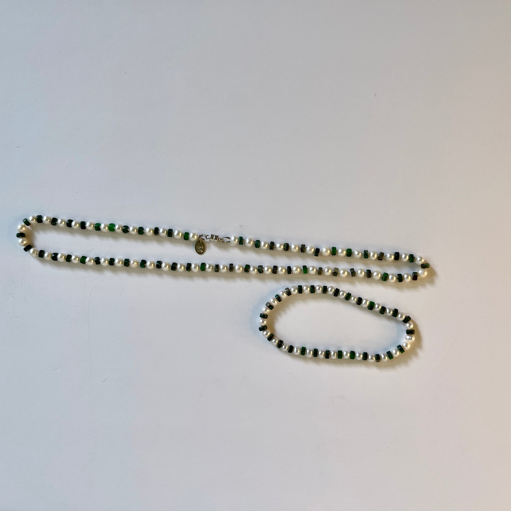 White Pearl and green jasper necklace and bracelet set on white background