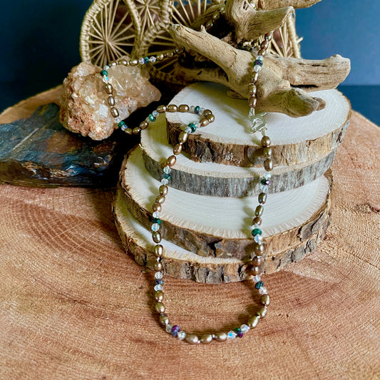 Beaded  Chocolate Pearls with Green Jasper and crystal necklace on a wooden surface with natural elements 