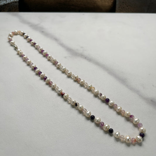 Pearl necklace with Purple jasper beads on a marble surface