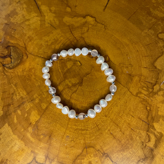 White freshwater Potato Pearls with Pink faceted Jasper on elastic, 7 1/2"on a wooden surface