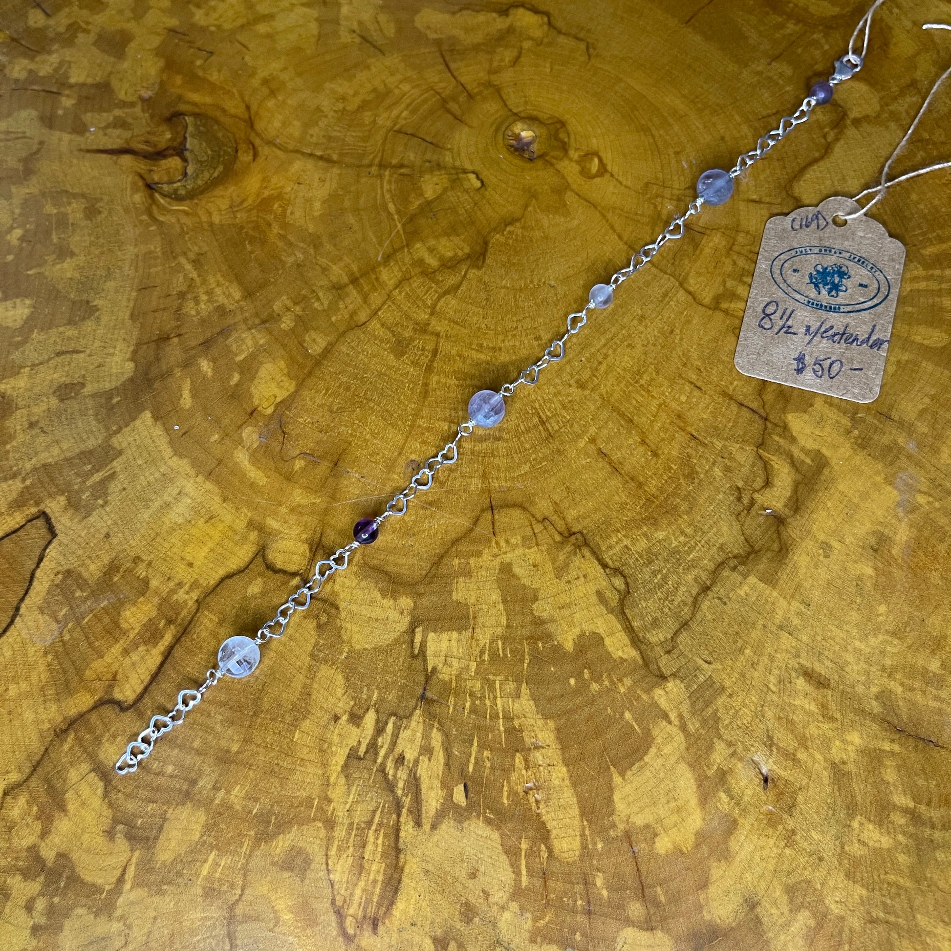 Sterling silver Heart chain bracelet with Fluorite beads on a wooden surface