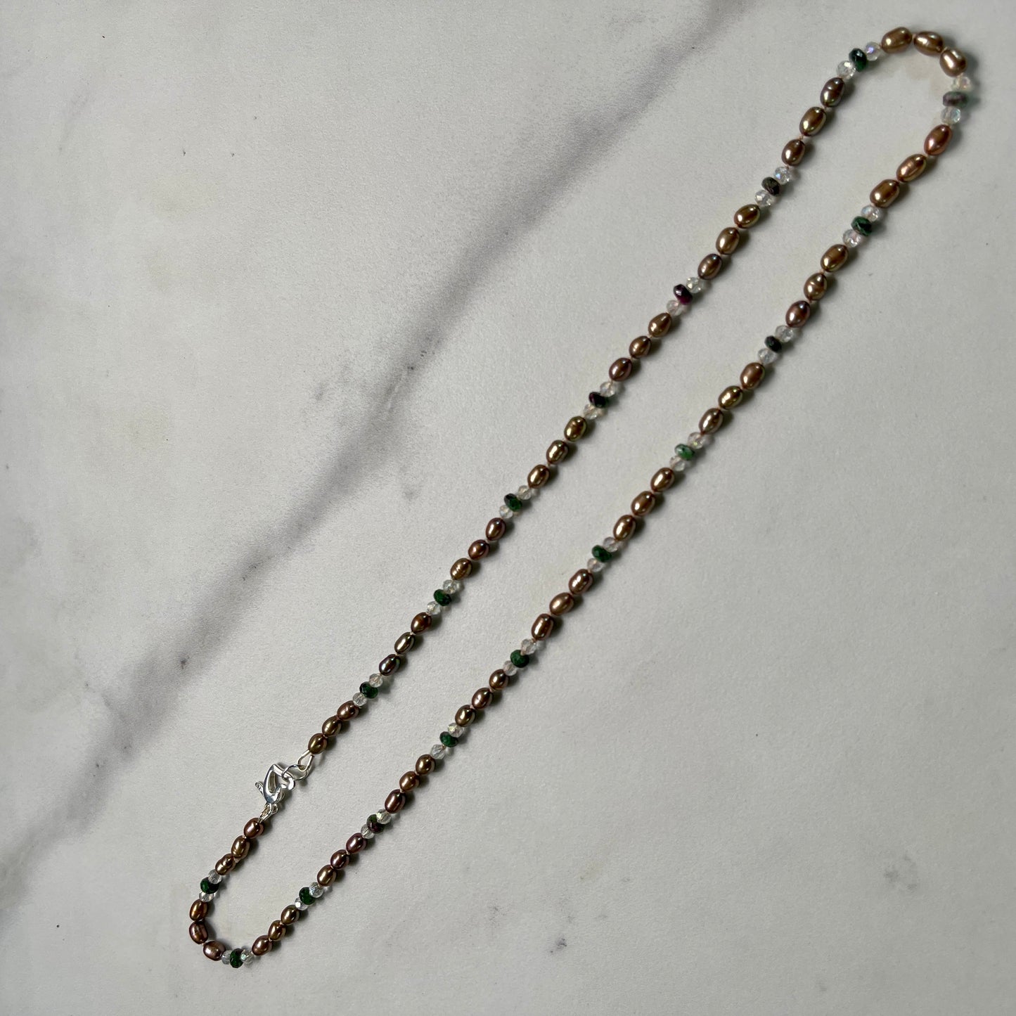 Beaded necklace on a marble surface