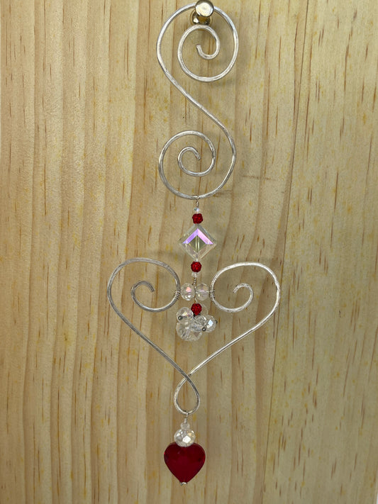 Heart shaped Decorative gold tone hammered metal wall/window Suncatcher with square crystal with red crystalwith red crystal accents ,ending with a  Red Heart shaped crystal drop, 10"ccents to multiple clear round beads with a red heart shaped crystal drop