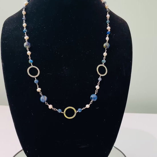 Pearls and Kyanite blue beads hand tooled on Sterling Silver wire on black mannequin bust