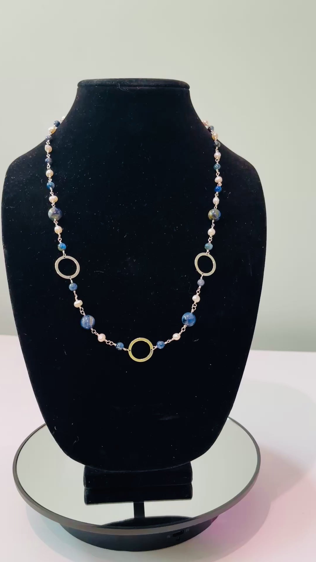 Pearls and Kyanite blue beads hand tooled on Sterling Silver wire on black mannequin bust